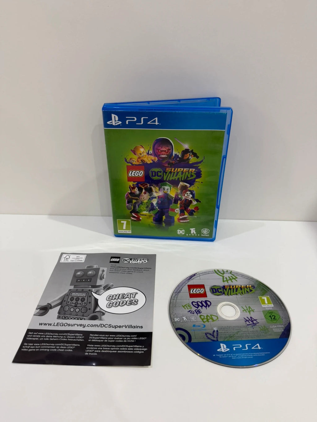 LEGO DC Super Villains PS4 game disc and case with colorful superhero graphics.