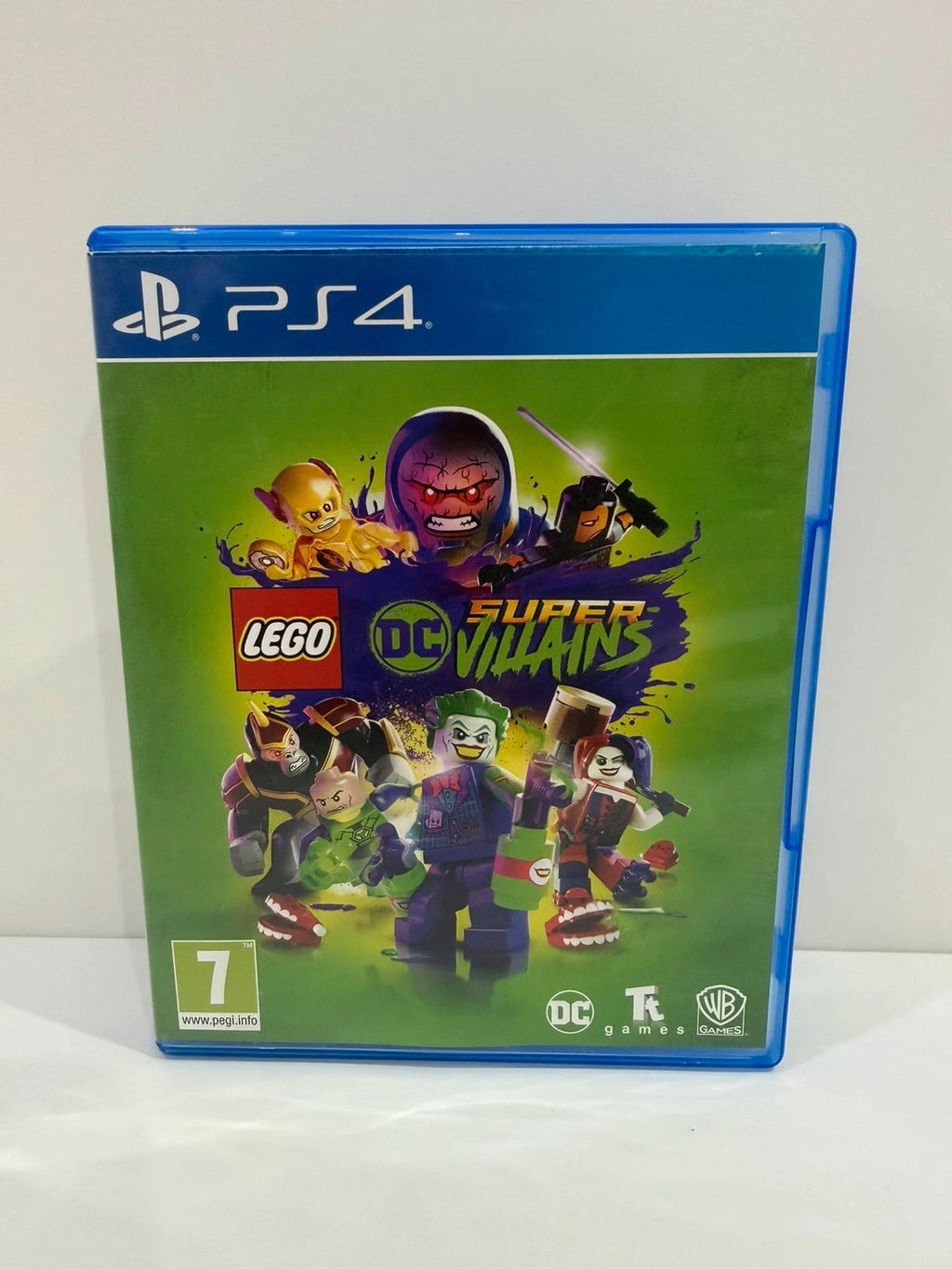 LEGO DC Super Villains PS4 game disc and case with colorful superhero graphics.
