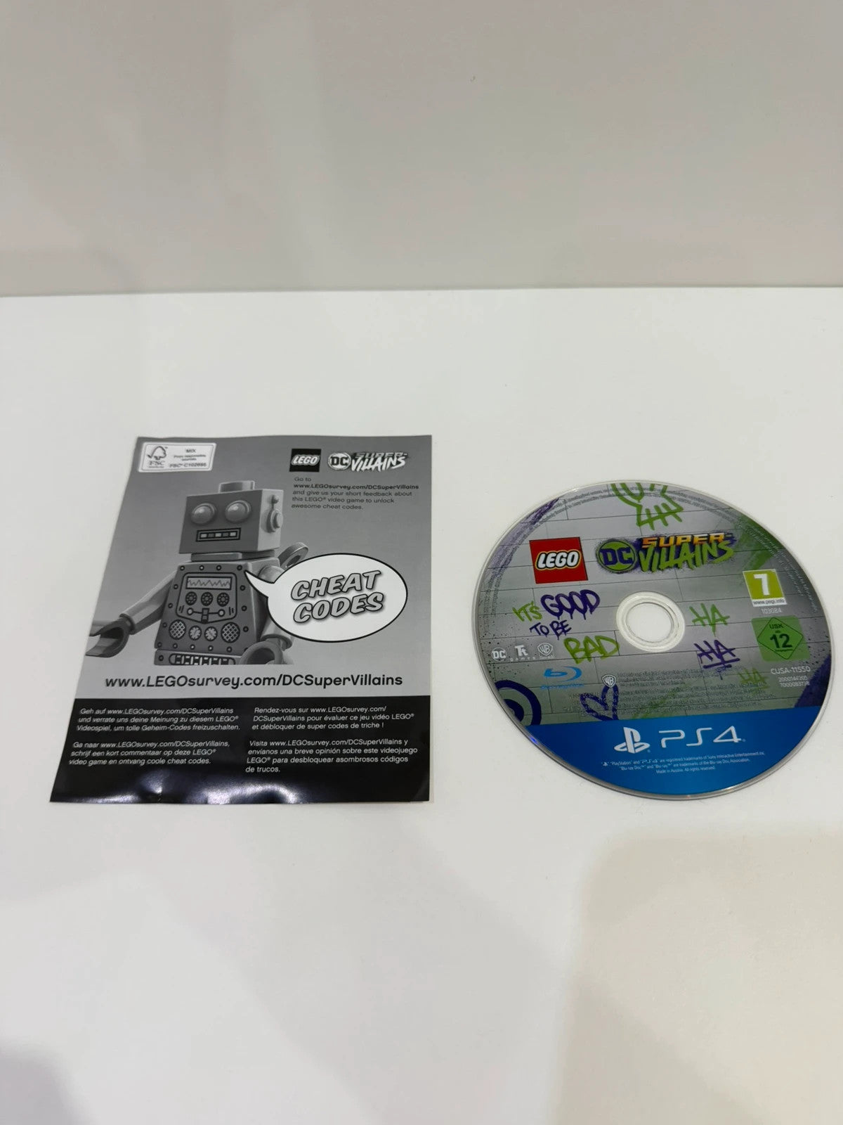 LEGO DC Super Villains PS4 game disc and case with colorful superhero graphics.