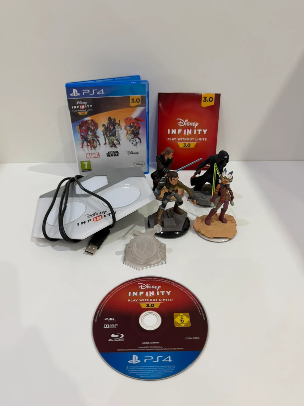 Disney Infinity 3.0 video game bundle for PS4 with game disc, base, and character figures.