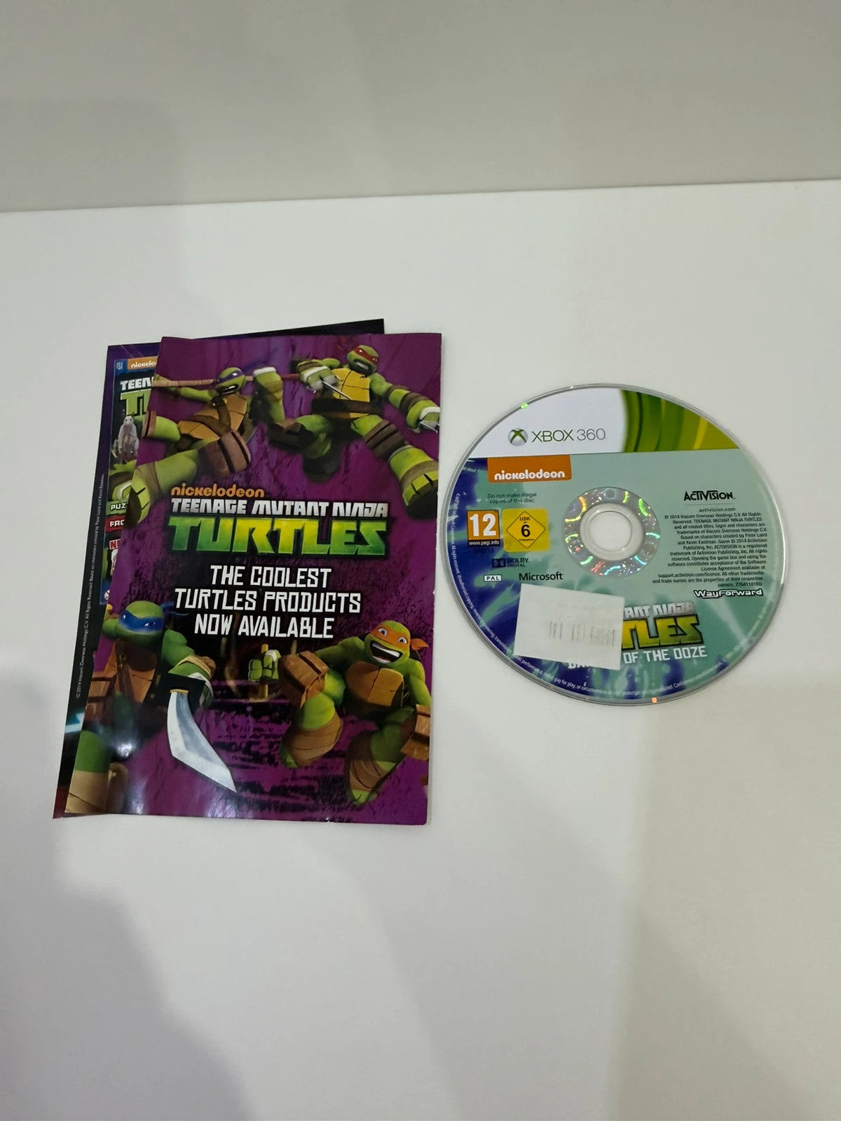 Teenage Mutant Ninja Turtles video game for Xbox 360 with colorful cover art and manual.