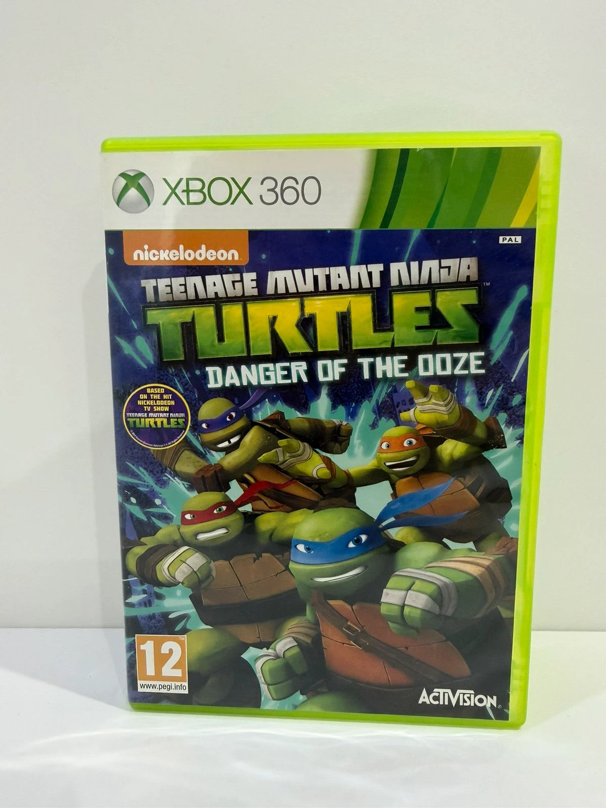 Teenage Mutant Ninja Turtles video game for Xbox 360 with colorful cover art and manual.