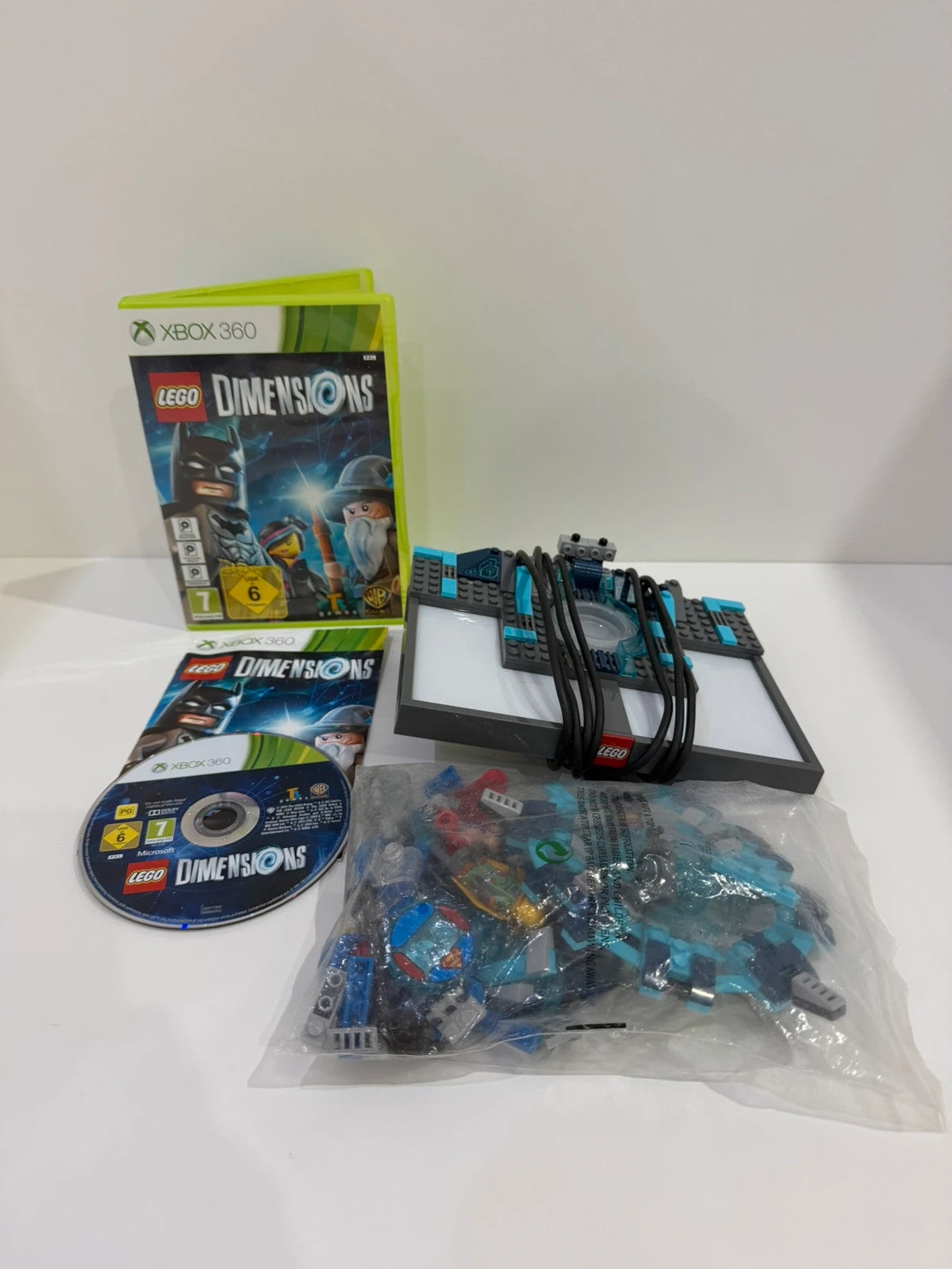 LEGO Dimensions video game bundle for Xbox 360 with USB Toy Pad and character figures.