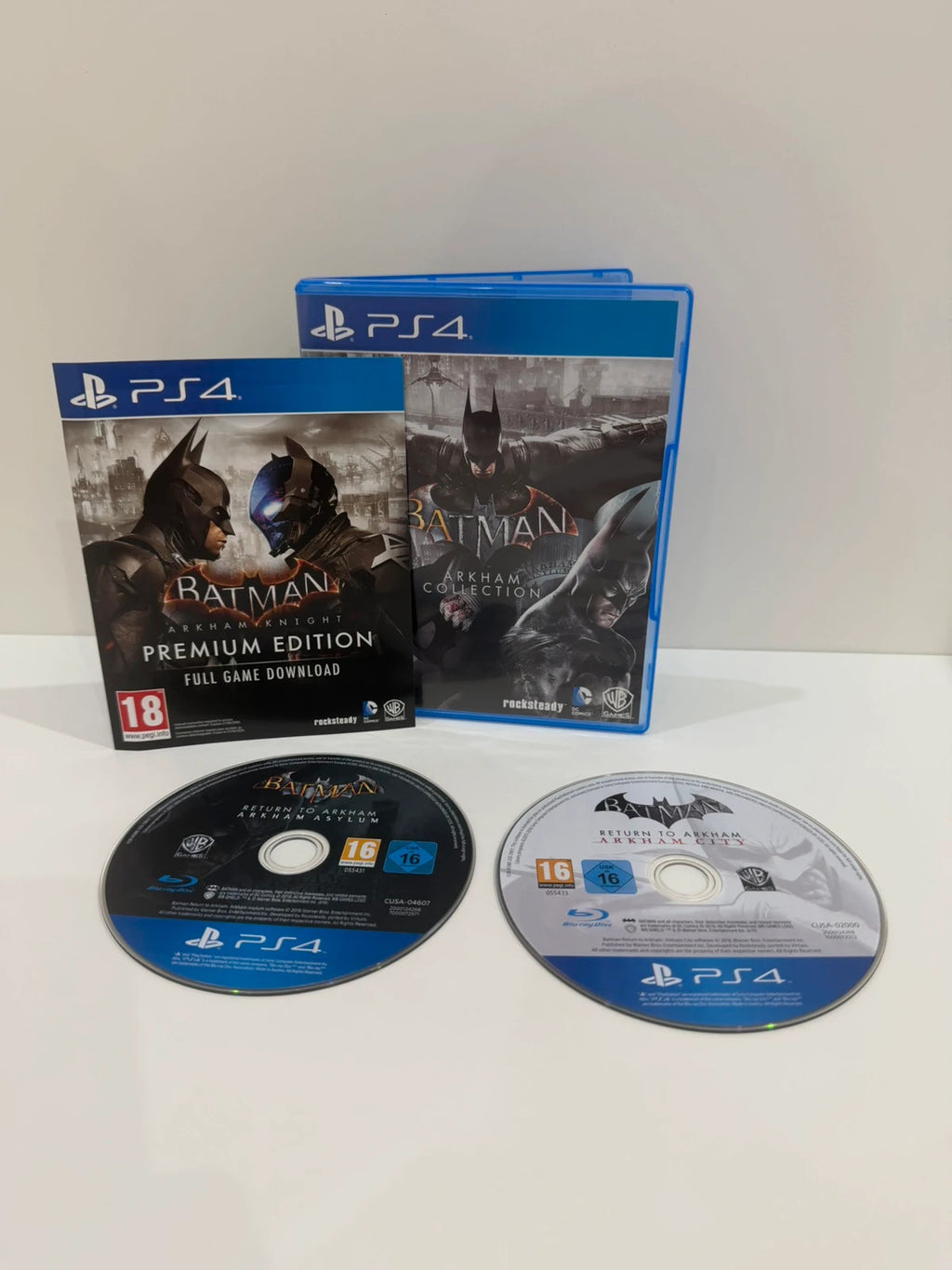 Batman Arkham Collection PS4 game case with cover art and two discs included.