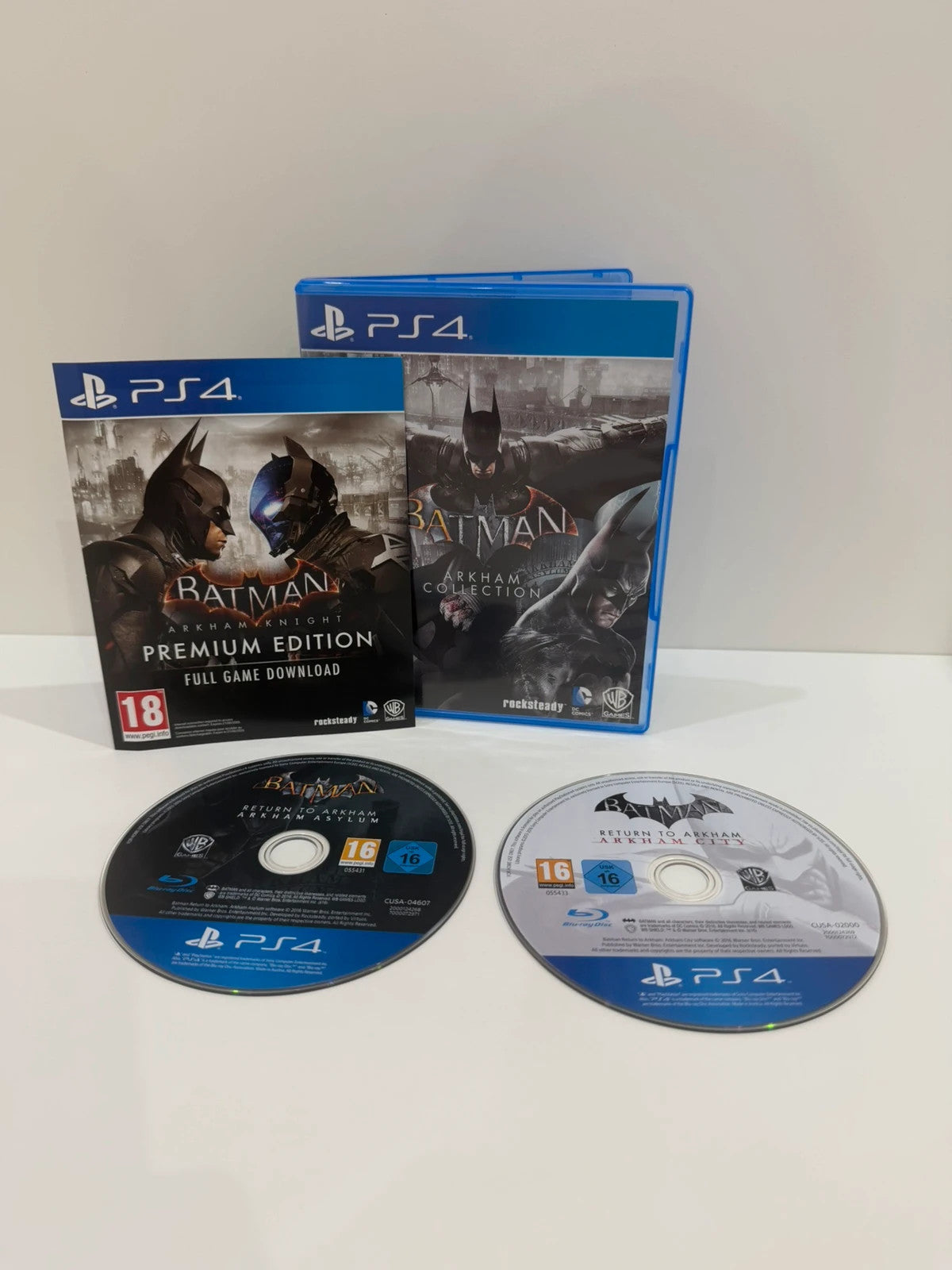 Batman Arkham Collection PS4 game case with cover art and two discs included.