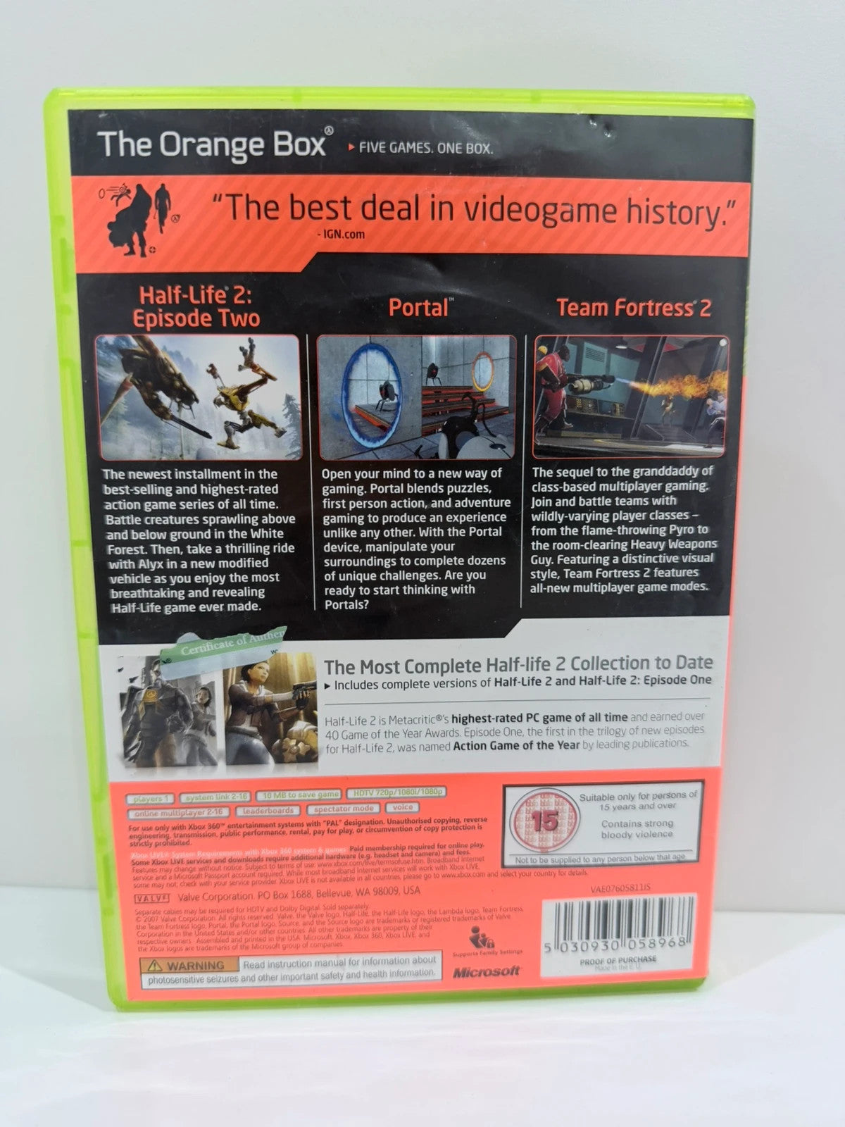 The Orange Box Xbox 360 game set, vibrant orange case with manual and disc.