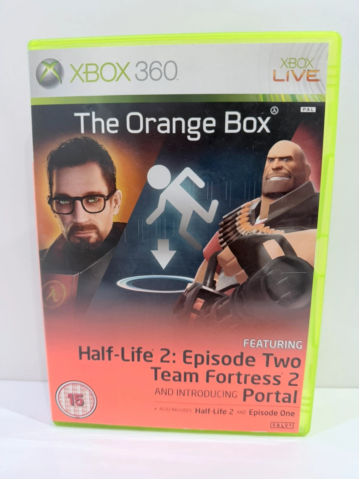 The Orange Box Xbox 360 game set, vibrant orange case with manual and disc.