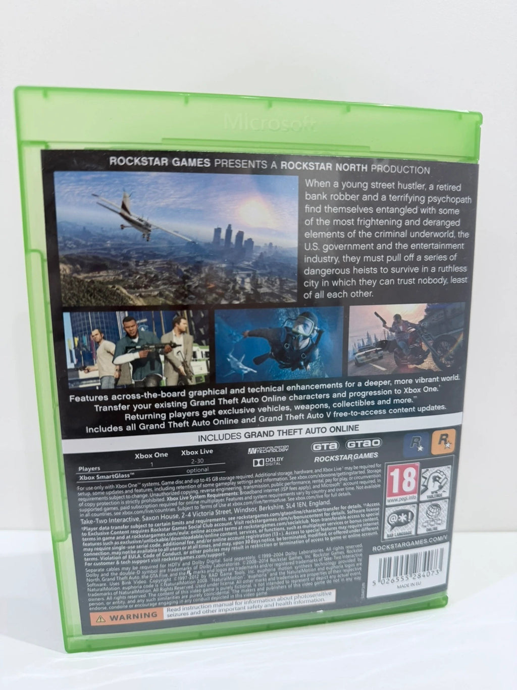 Grand Theft Auto V Xbox One game case with disc, manual, and map included.