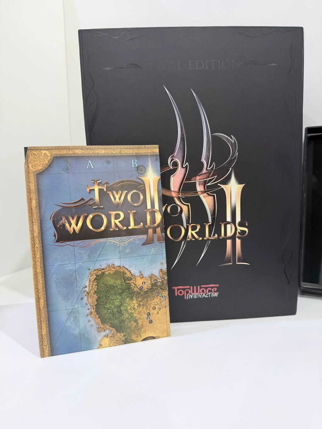Two Worlds II Royal Edition Xbox 360 collector's statue with detailed artwork and packaging.
