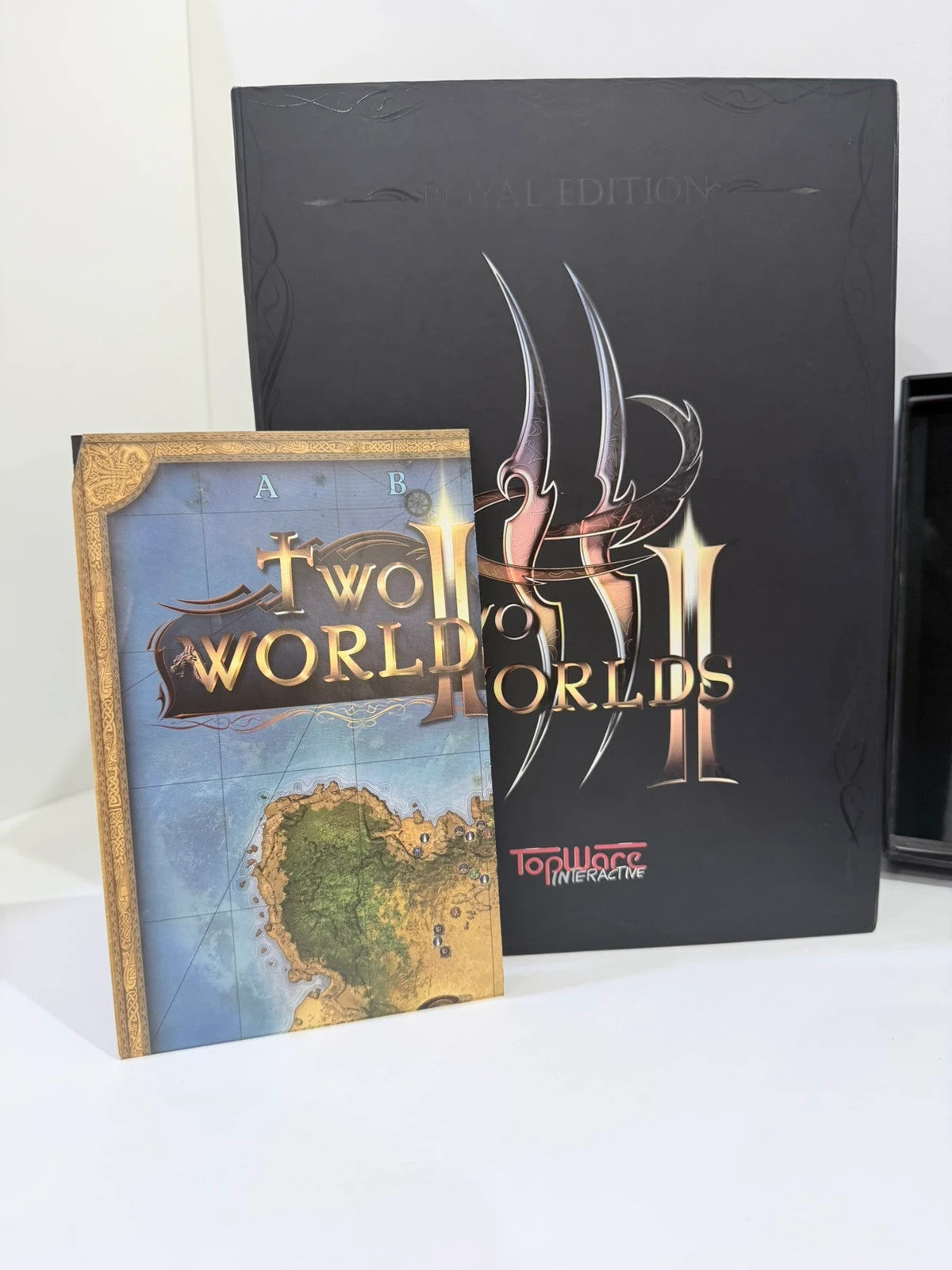 Two Worlds II Royal Edition Xbox 360 collector's statue with detailed artwork and packaging.