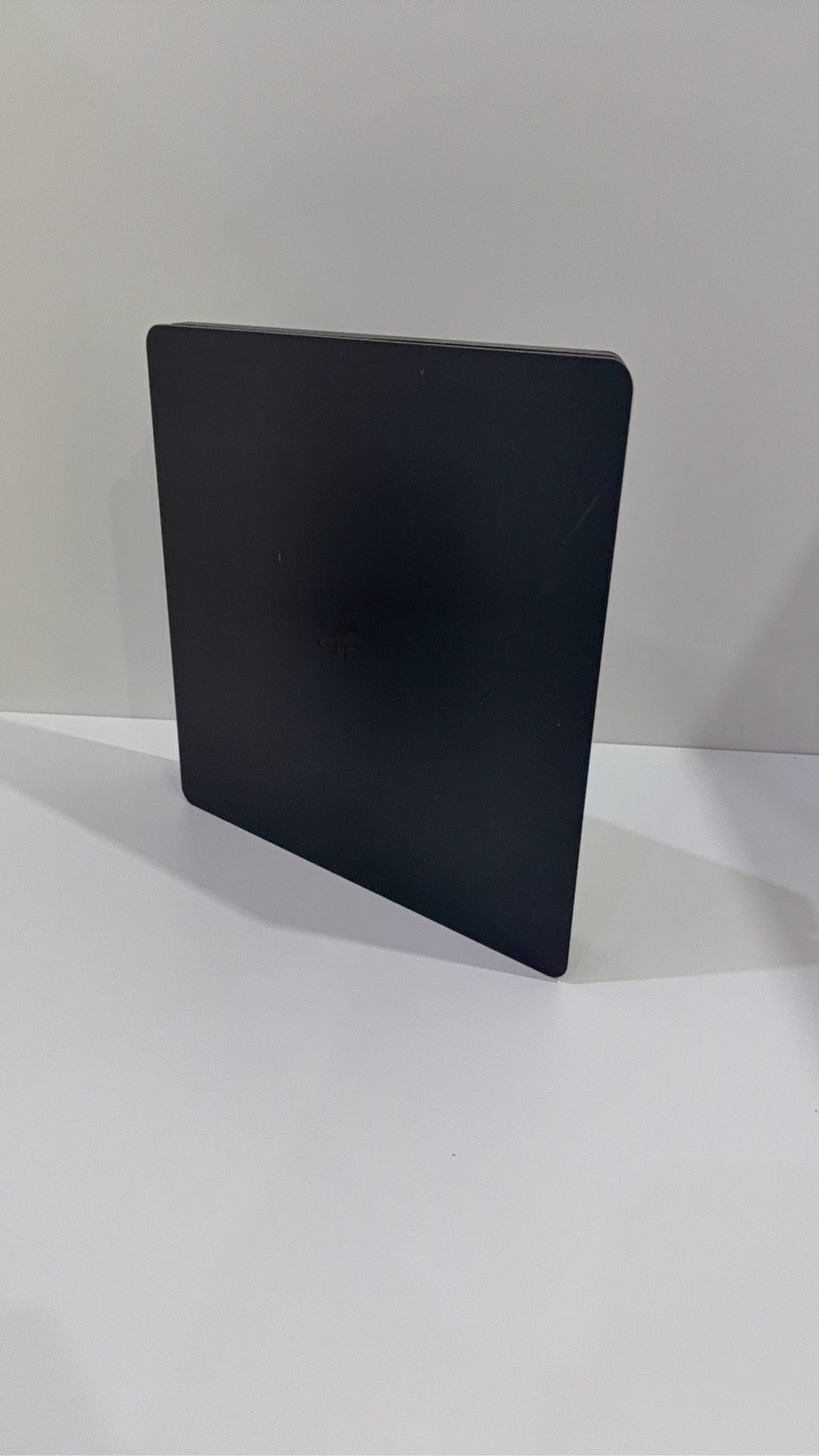 Sony PlayStation 4 Slim 500GB black console with one controller, power and HDMI cables.