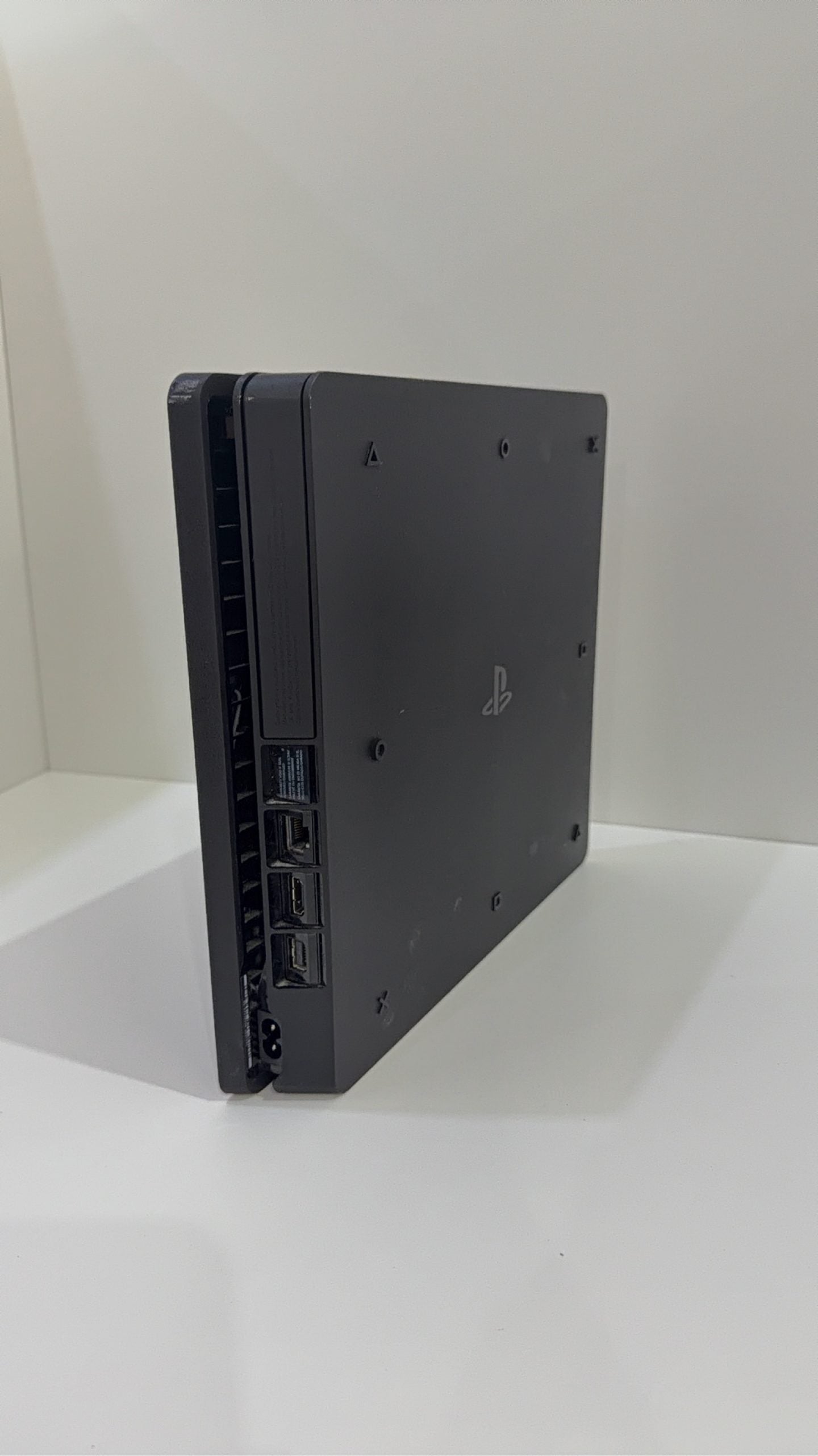 Sony PlayStation 4 Slim 500GB black console with one controller, power and HDMI cables.