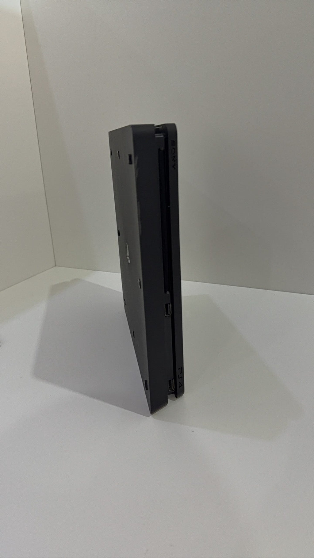 Sony PlayStation 4 Slim 500GB black console with one controller, power and HDMI cables.