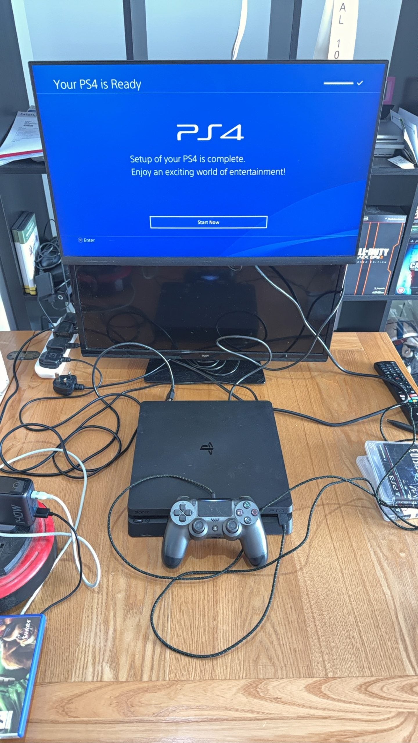 Sony PlayStation 4 Slim 500GB black console with one controller, power and HDMI cables.