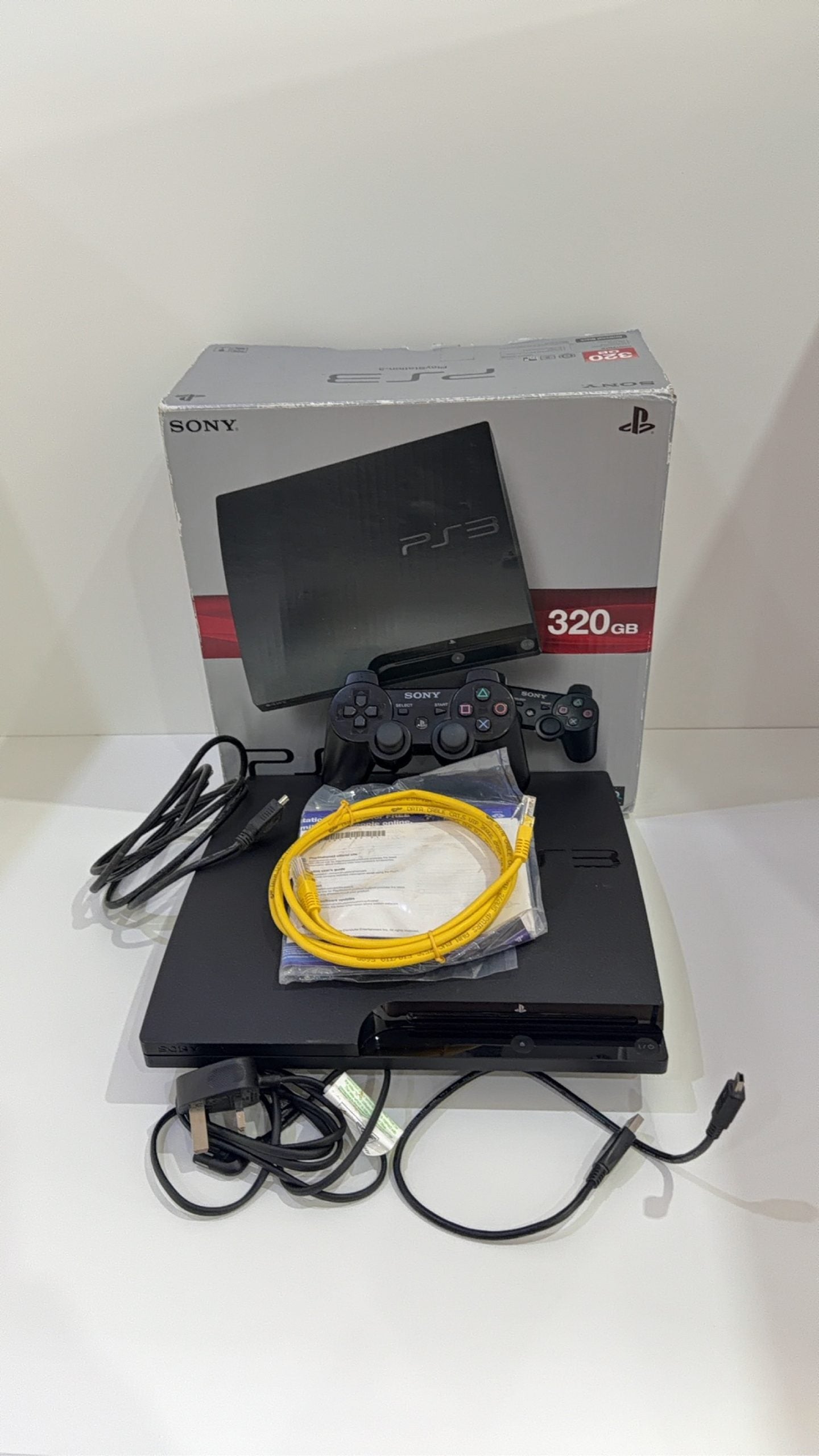 Sony PlayStation 3 PS3 320GB boxed console with official controller, cables, and original booklet.