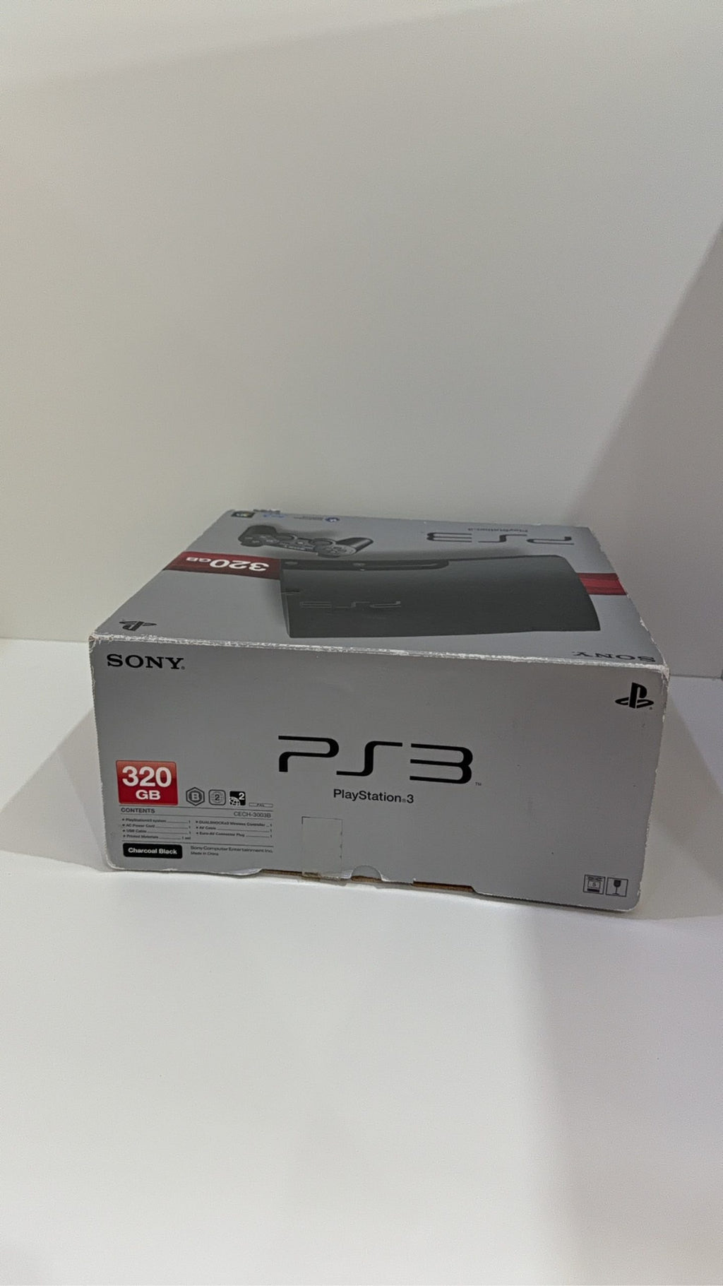 Sony PlayStation 3 PS3 320GB boxed console with official controller, cables, and original booklet.