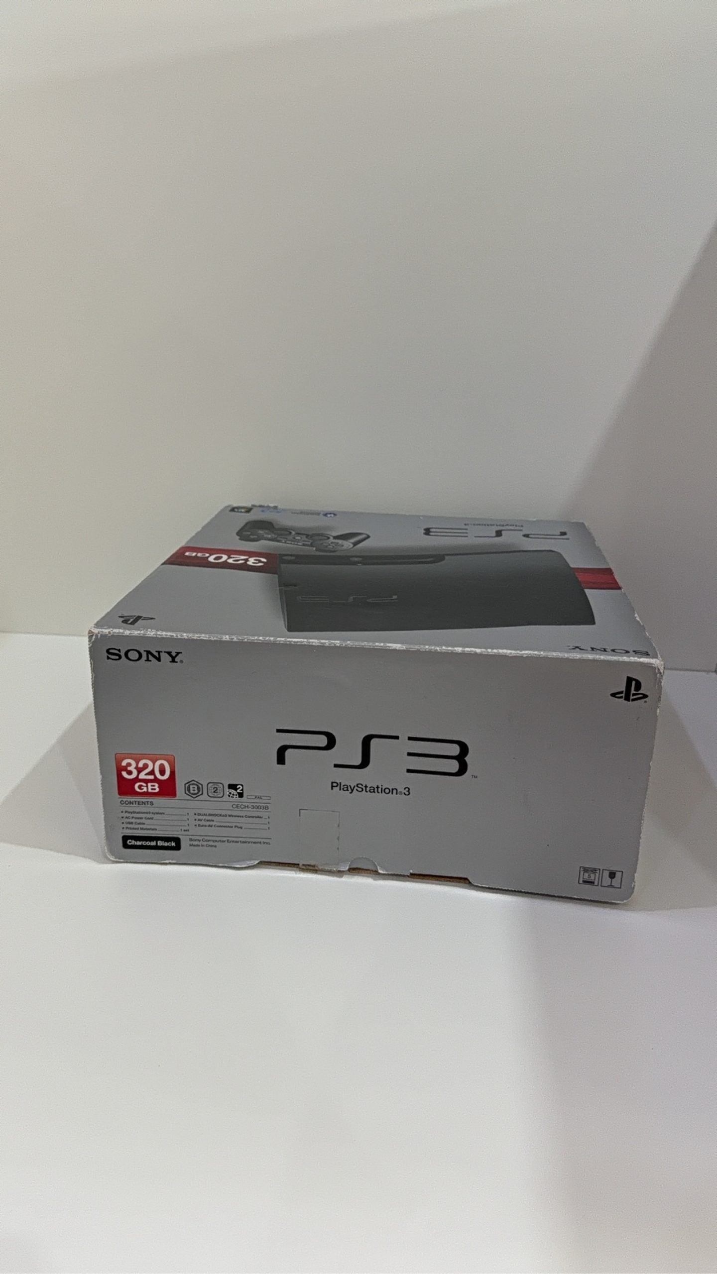 Sony PlayStation 3 PS3 320GB boxed console with official controller, cables, and original booklet.