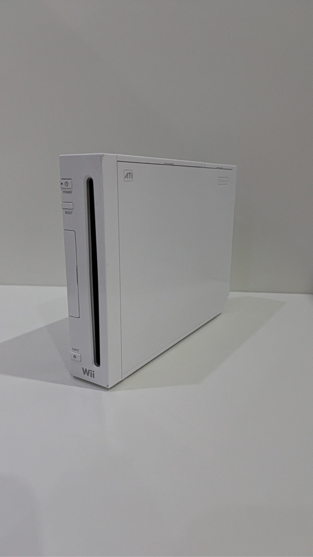 White Nintendo Wii console bundle with official Wii Remote, Nunchuk, cables, and Wii Play game.