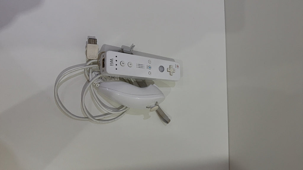 White Nintendo Wii console bundle with official Wii Remote, Nunchuk, cables, and Wii Play game.