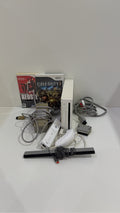 White Nintendo Wii console bundle with official Wii Remote, Nunchuk, and two boxed games.
