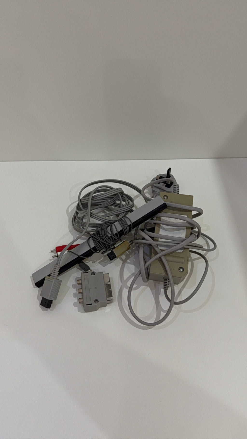 White Nintendo Wii console bundle with official Wii Remote, Nunchuk, and two boxed games.