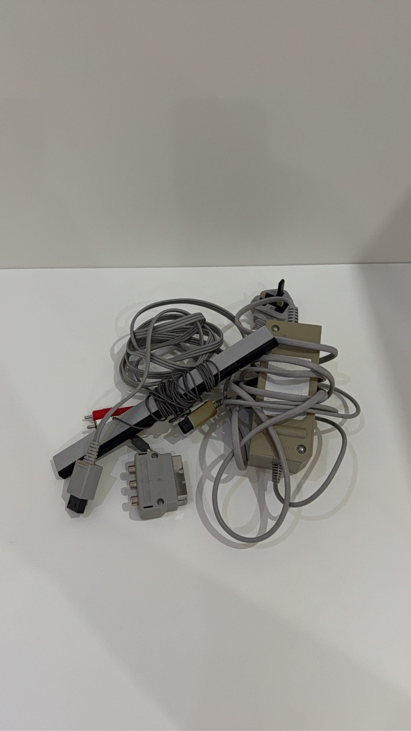 White Nintendo Wii console bundle with official Wii Remote, Nunchuk, and two boxed games.
