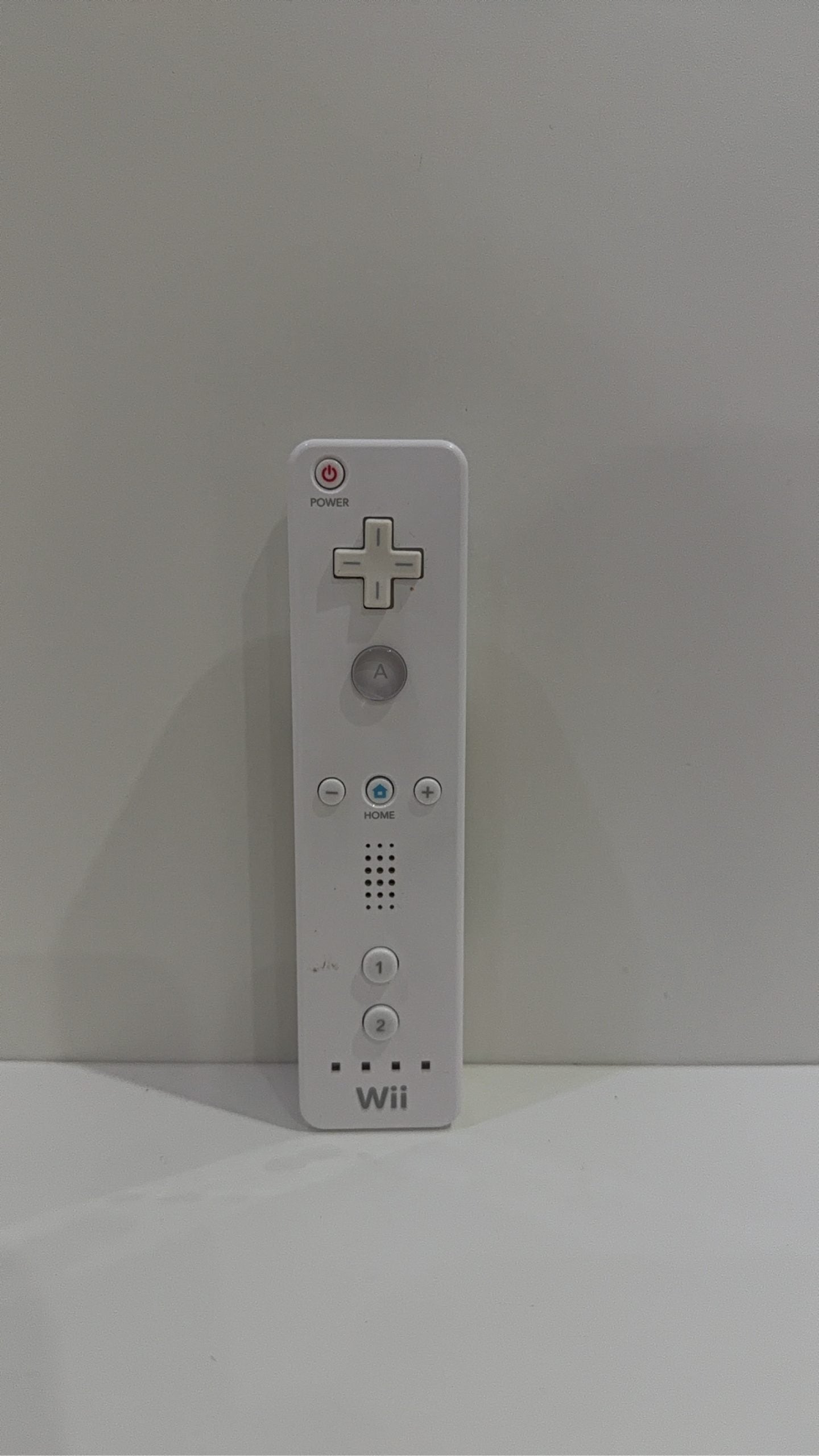 Official Nintendo Wii Remote Controller in white with signs of battery corrosion.