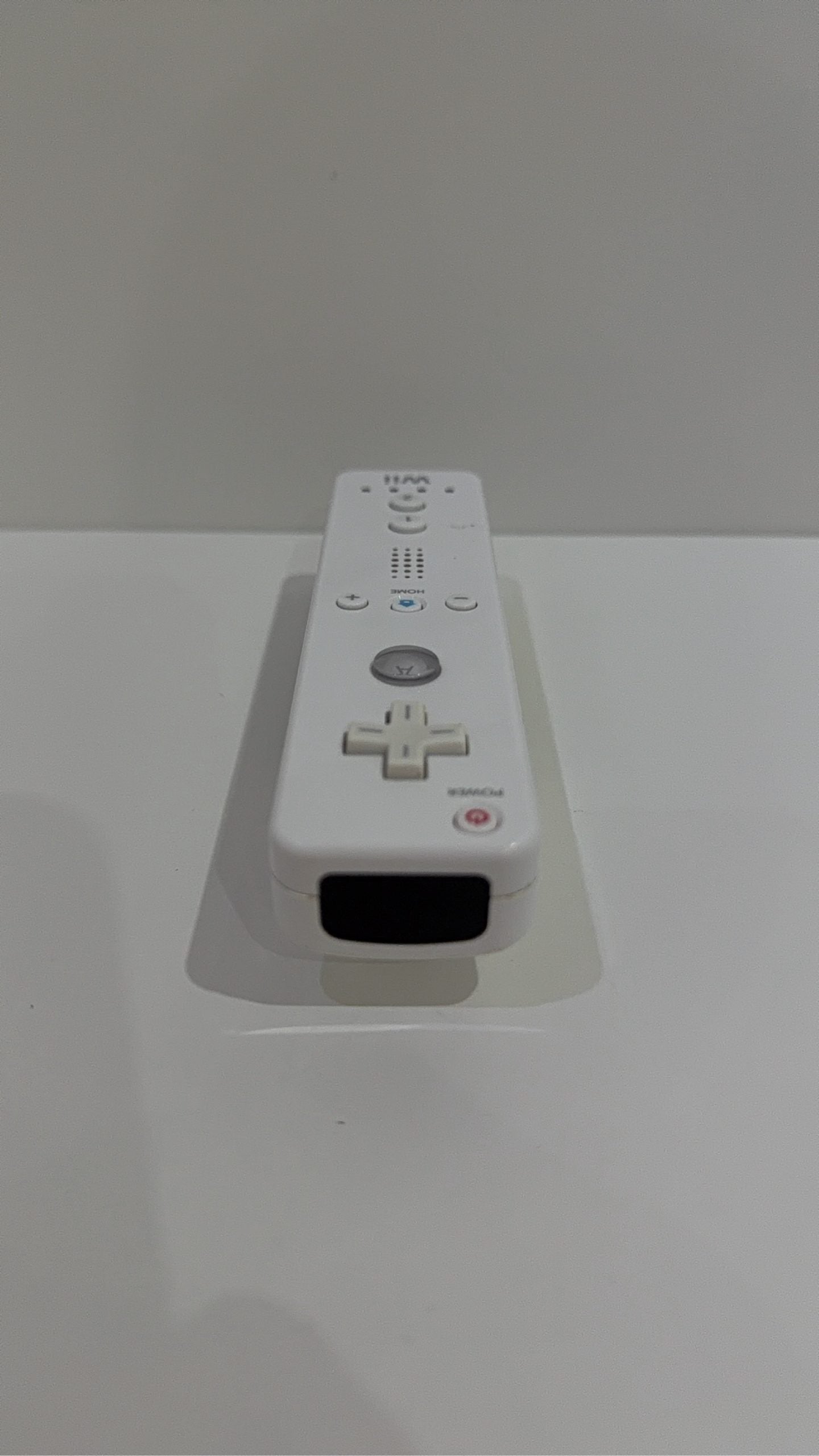 Official Nintendo Wii Remote Controller in white with signs of battery corrosion.