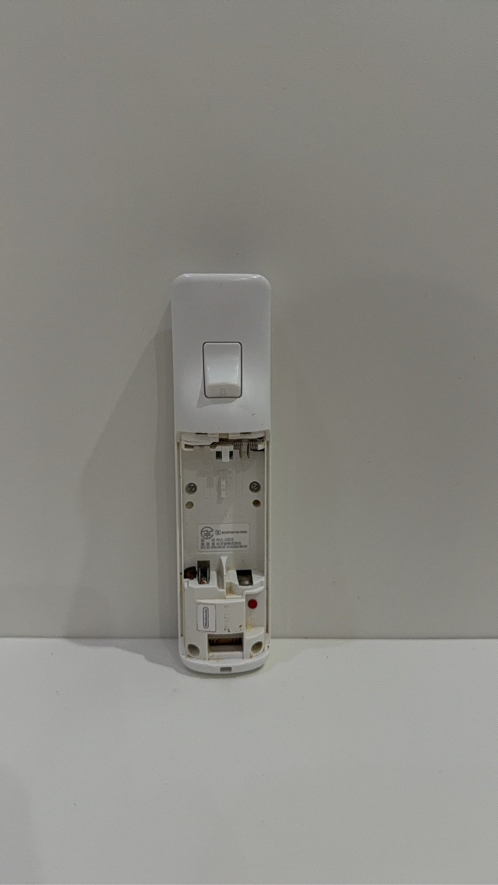 Official Nintendo Wii Remote Controller with light corrosion, tested and cleaned.
