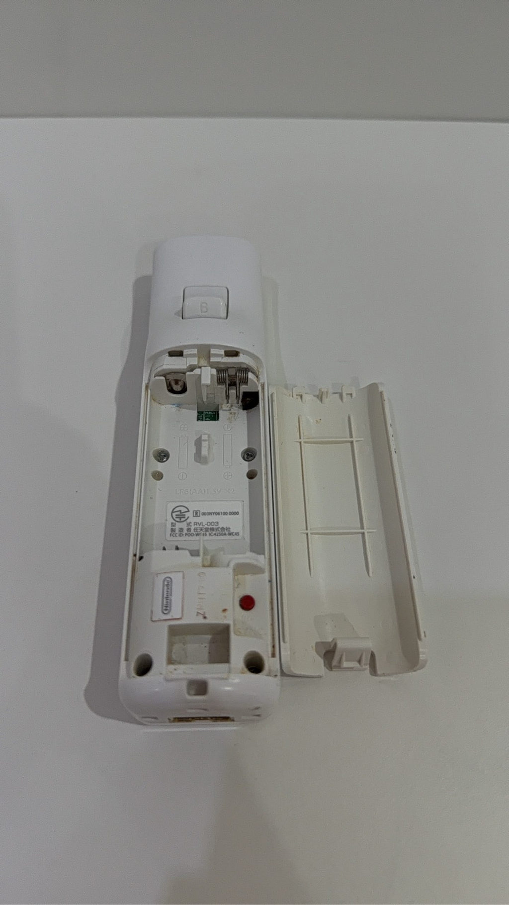 Official Nintendo Wii Remote Controller with light corrosion, tested and cleaned.