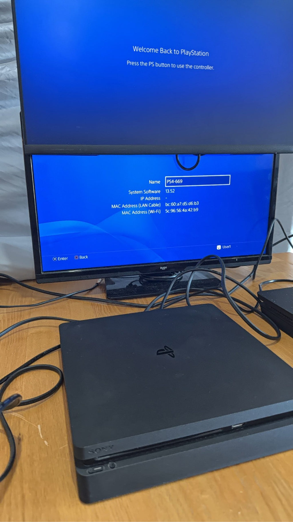 PlayStation 4 Slim PS4 Black 500GB console with official silver Dualshock 4 controller.