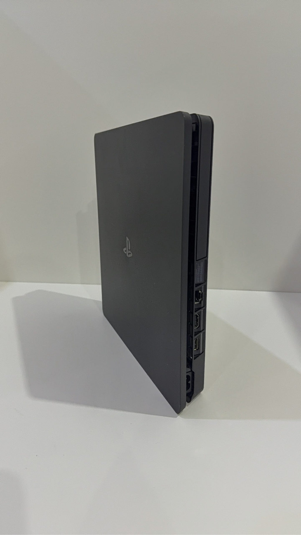 PlayStation 4 Slim PS4 Black 500GB console with official silver Dualshock 4 controller.