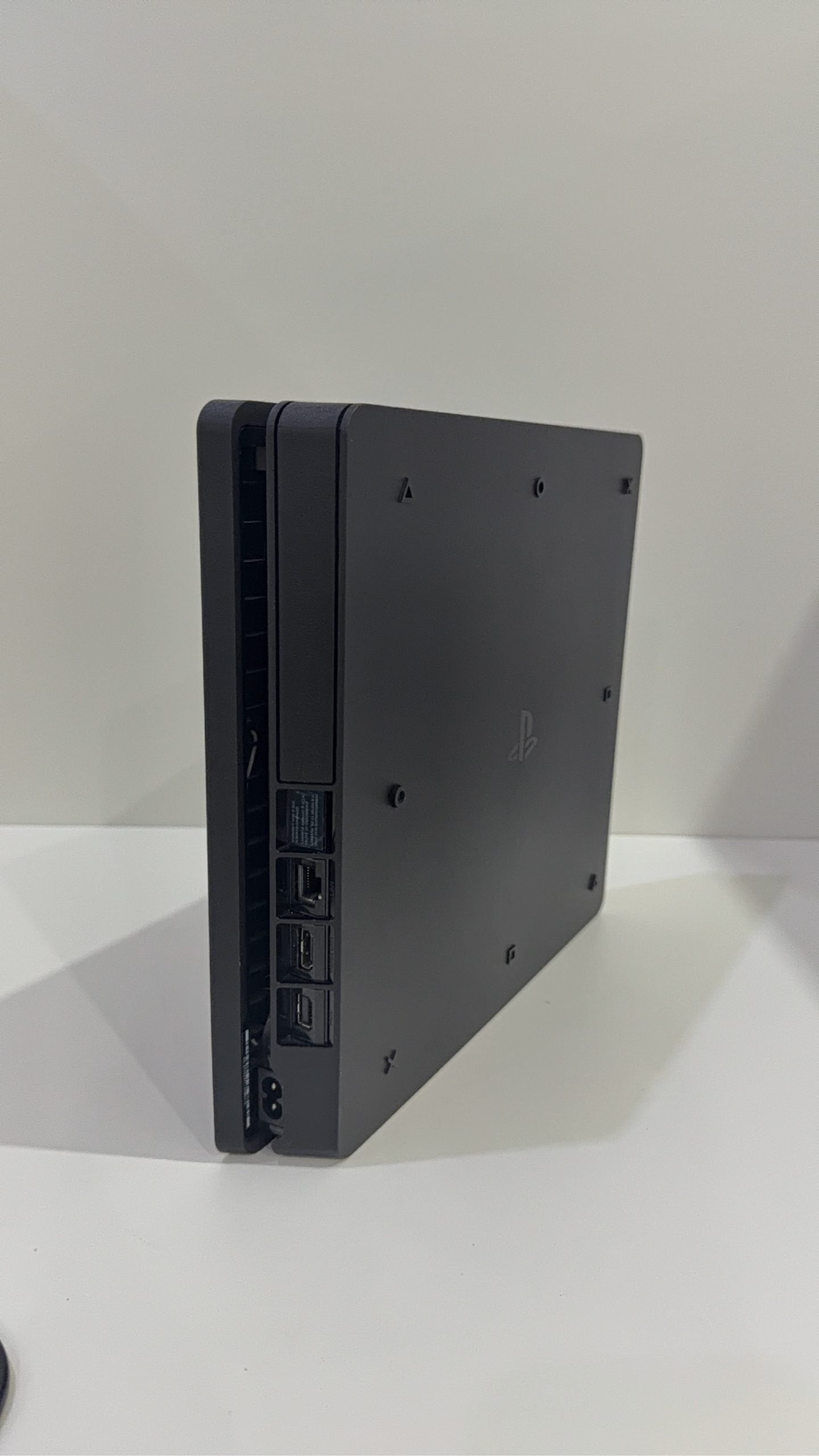 PlayStation 4 Slim PS4 Black 500GB console with official silver Dualshock 4 controller.