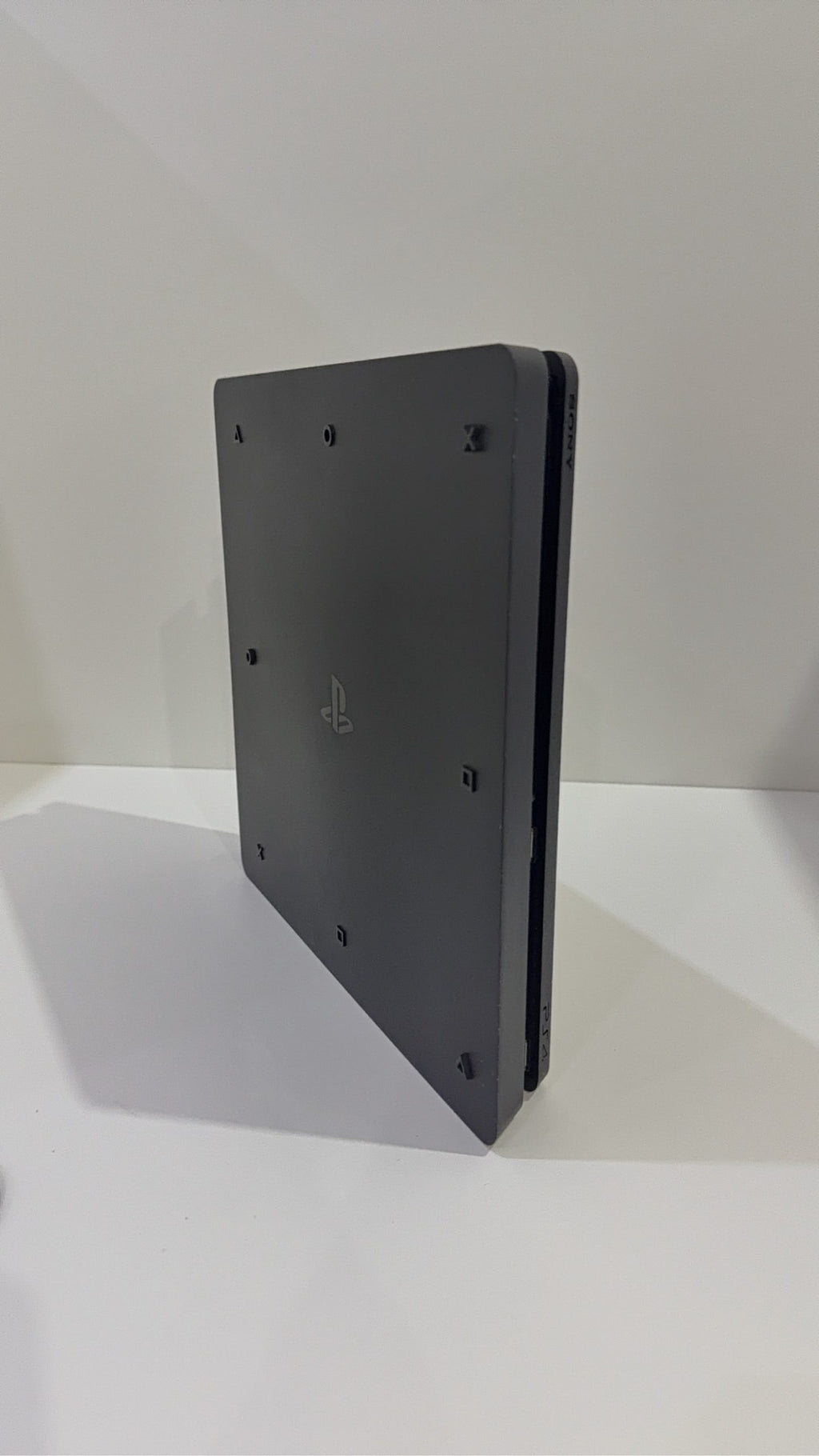 PlayStation 4 Slim PS4 Black 500GB console with official silver Dualshock 4 controller.
