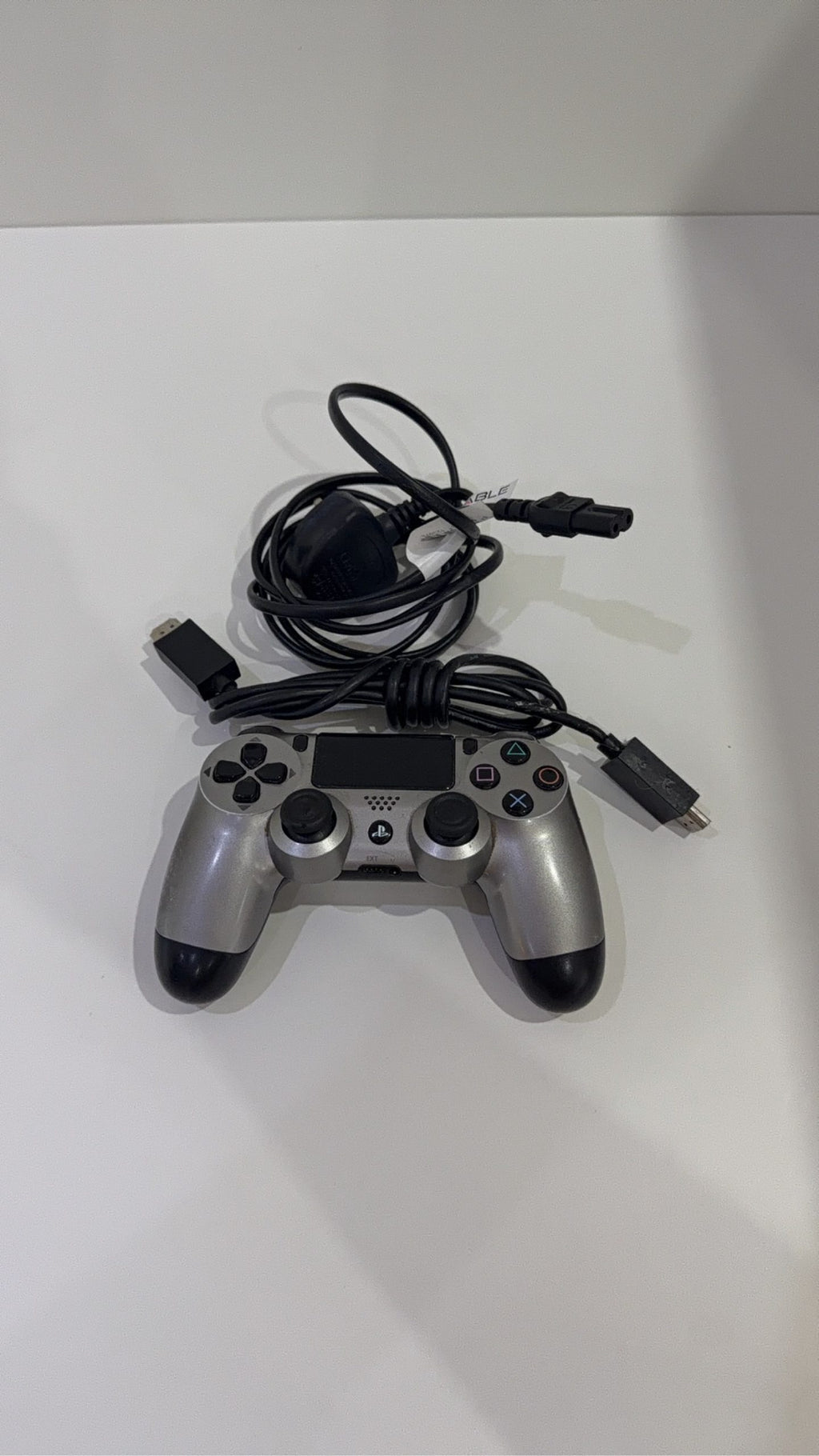 PlayStation 4 Slim PS4 Black 500GB console with official silver Dualshock 4 controller.