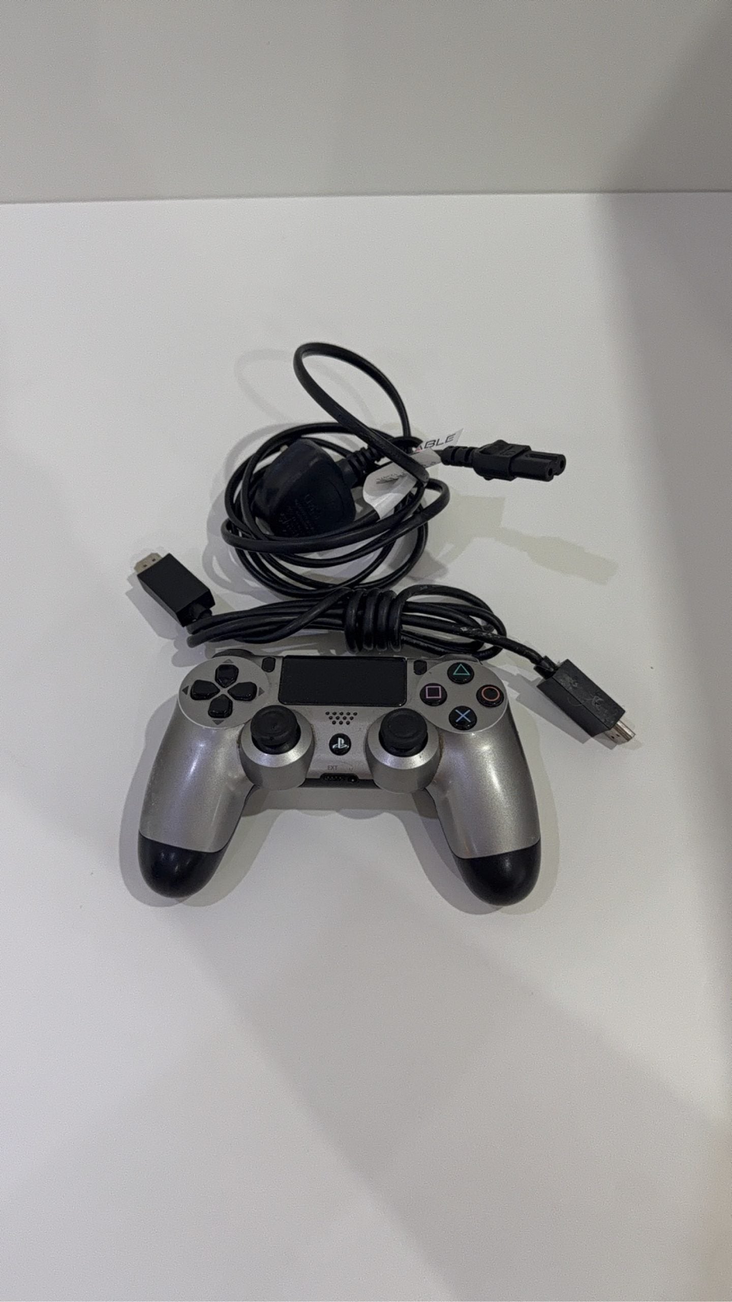 PlayStation 4 Slim PS4 Black 500GB console with official silver Dualshock 4 controller.