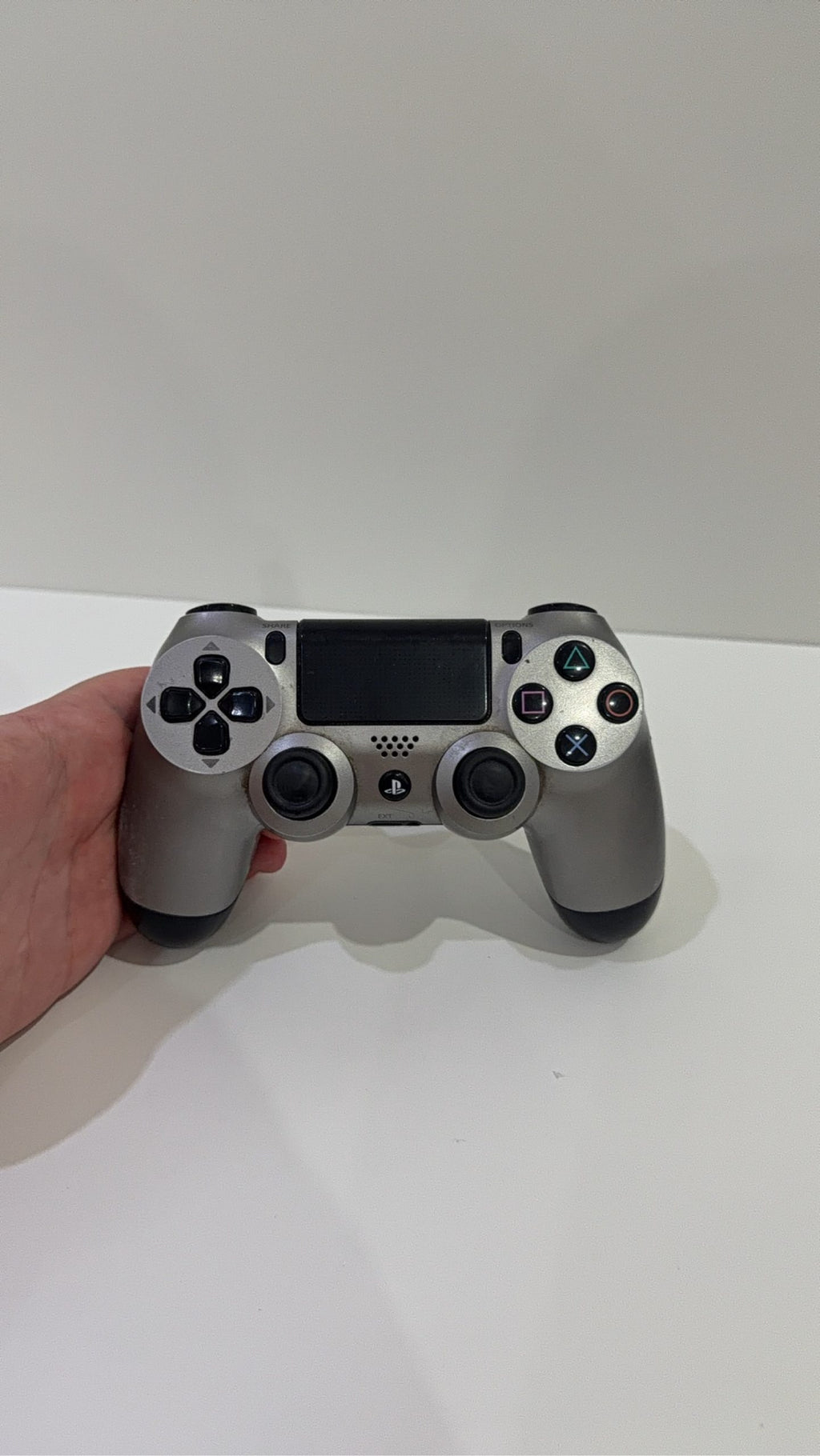 PlayStation 4 Slim PS4 Black 500GB console with official silver Dualshock 4 controller.