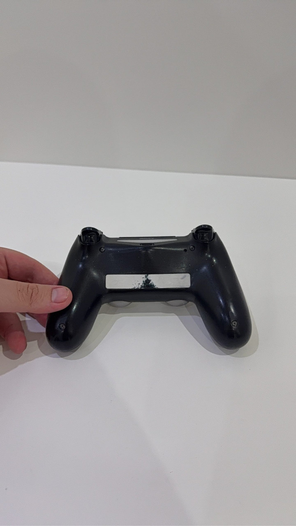 PlayStation 4 Slim PS4 Black 500GB console with official silver Dualshock 4 controller.