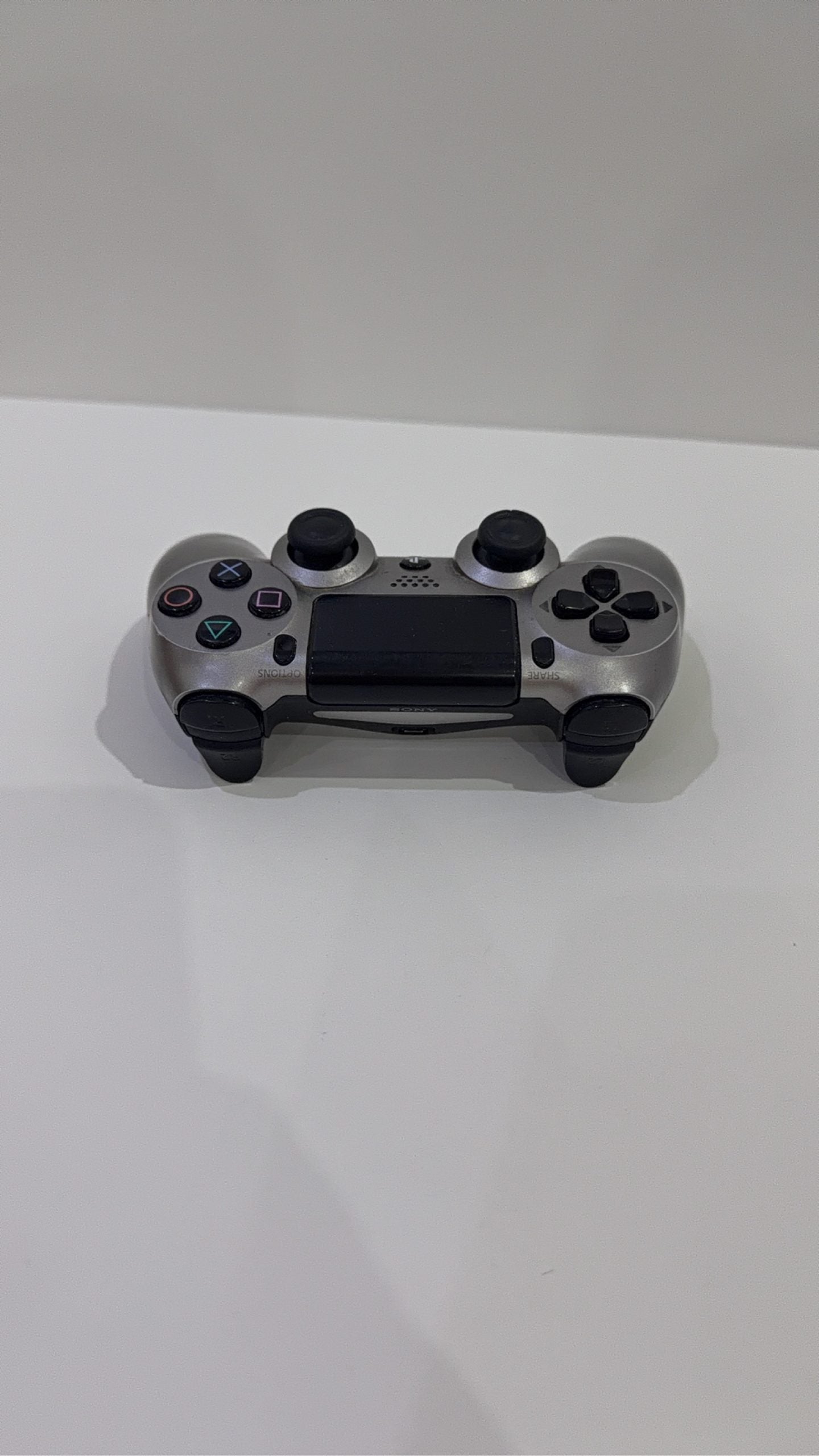 PlayStation 4 Slim PS4 Black 500GB console with official silver Dualshock 4 controller.