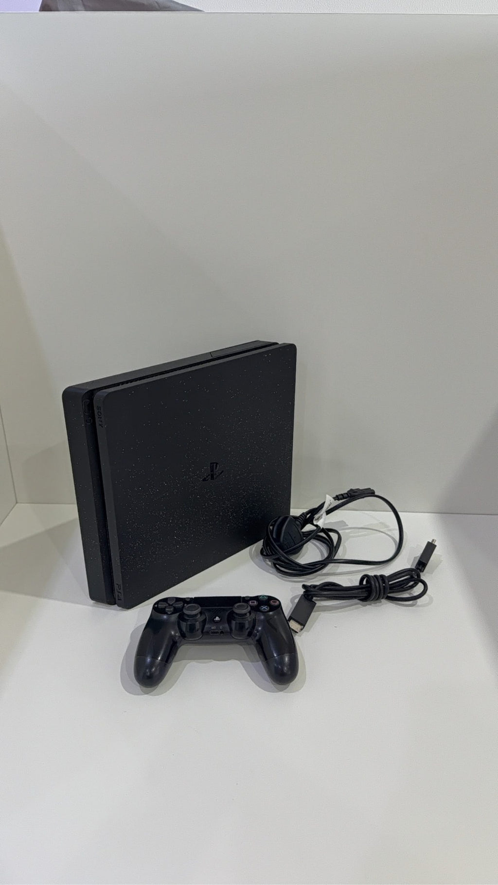 PS4 Slim PlayStation 4 Black 500GB console with official Dualshock 4 controller and cables.