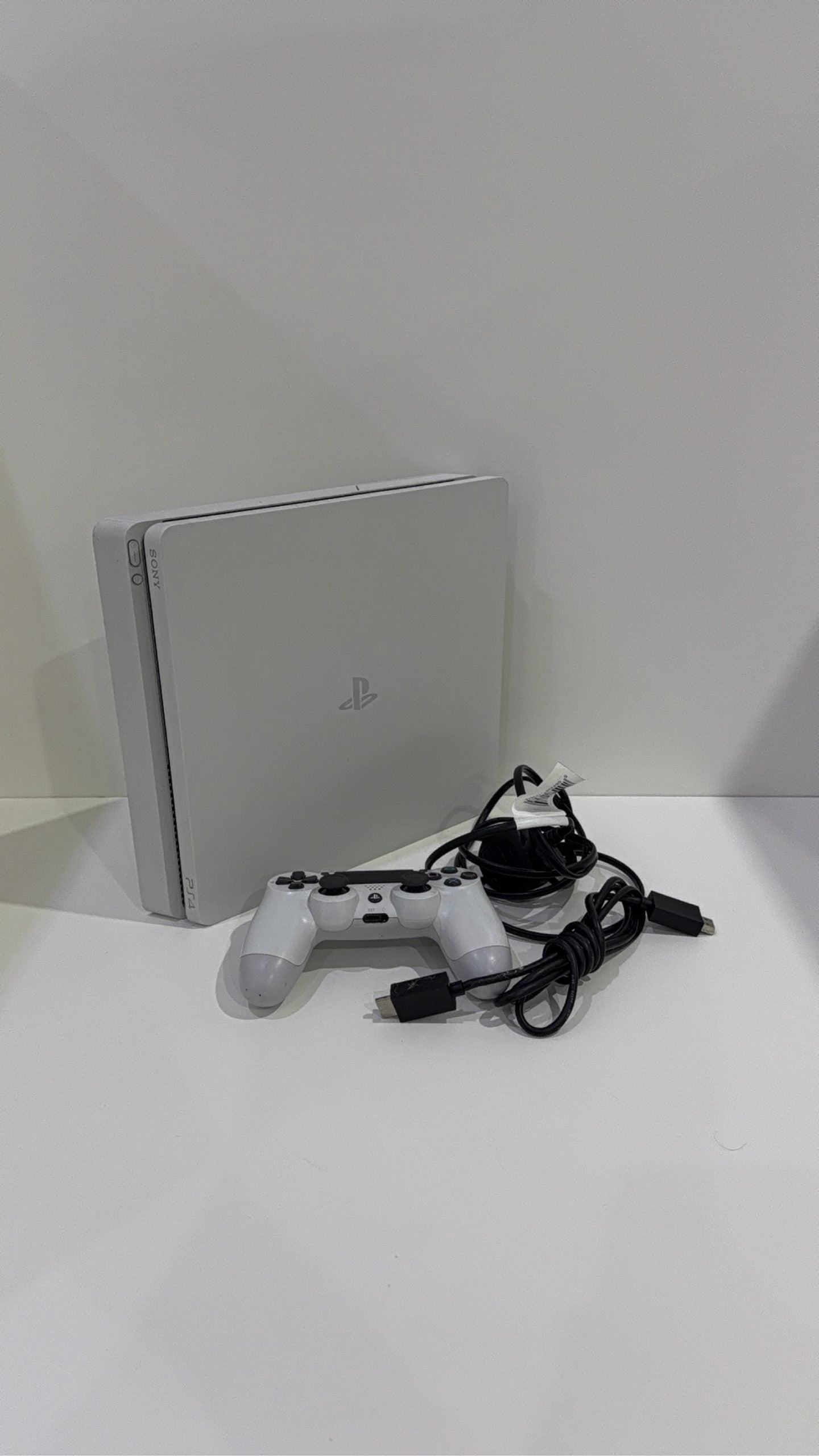 Sony PlayStation 4 Slim White 500GB Console with Controller and Cables, pre-owned gaming system.