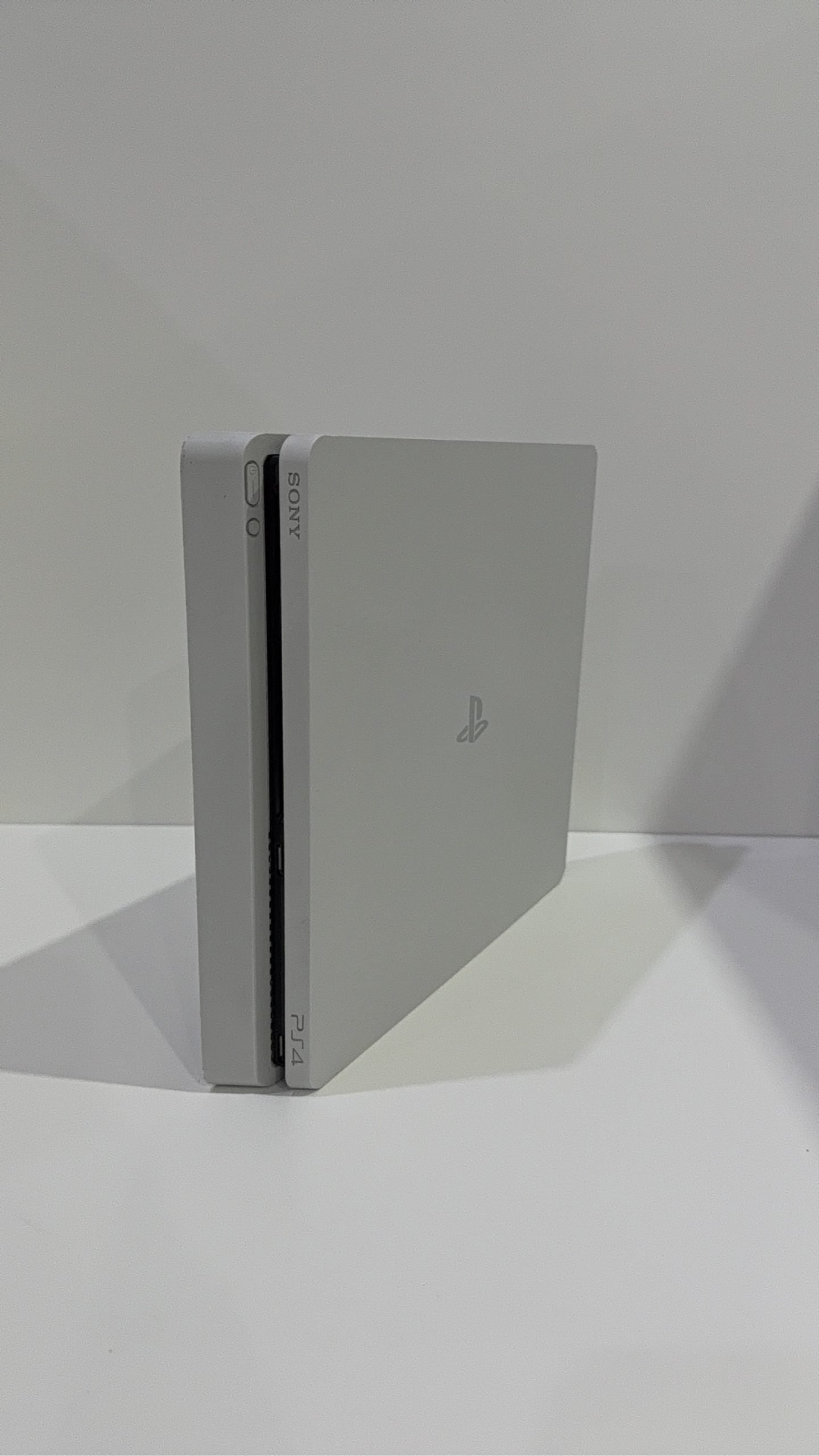 Sony PlayStation 4 Slim White 500GB Console with Controller and Cables, pre-owned gaming system.