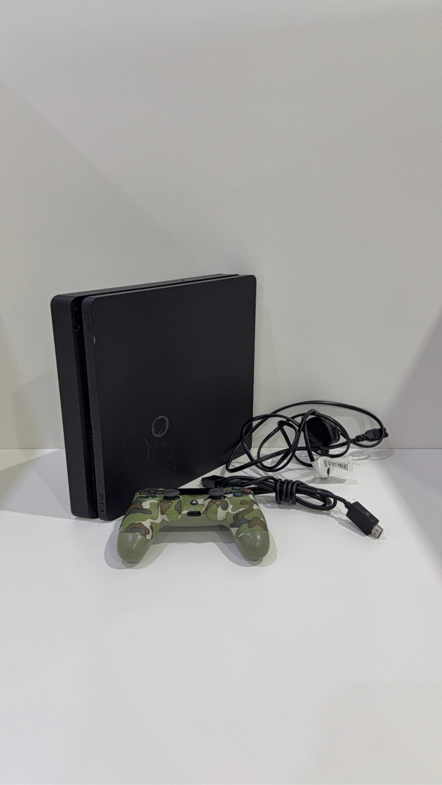 Sony PlayStation 4 Slim 500GB Black Console with Camo Controller and power cables.