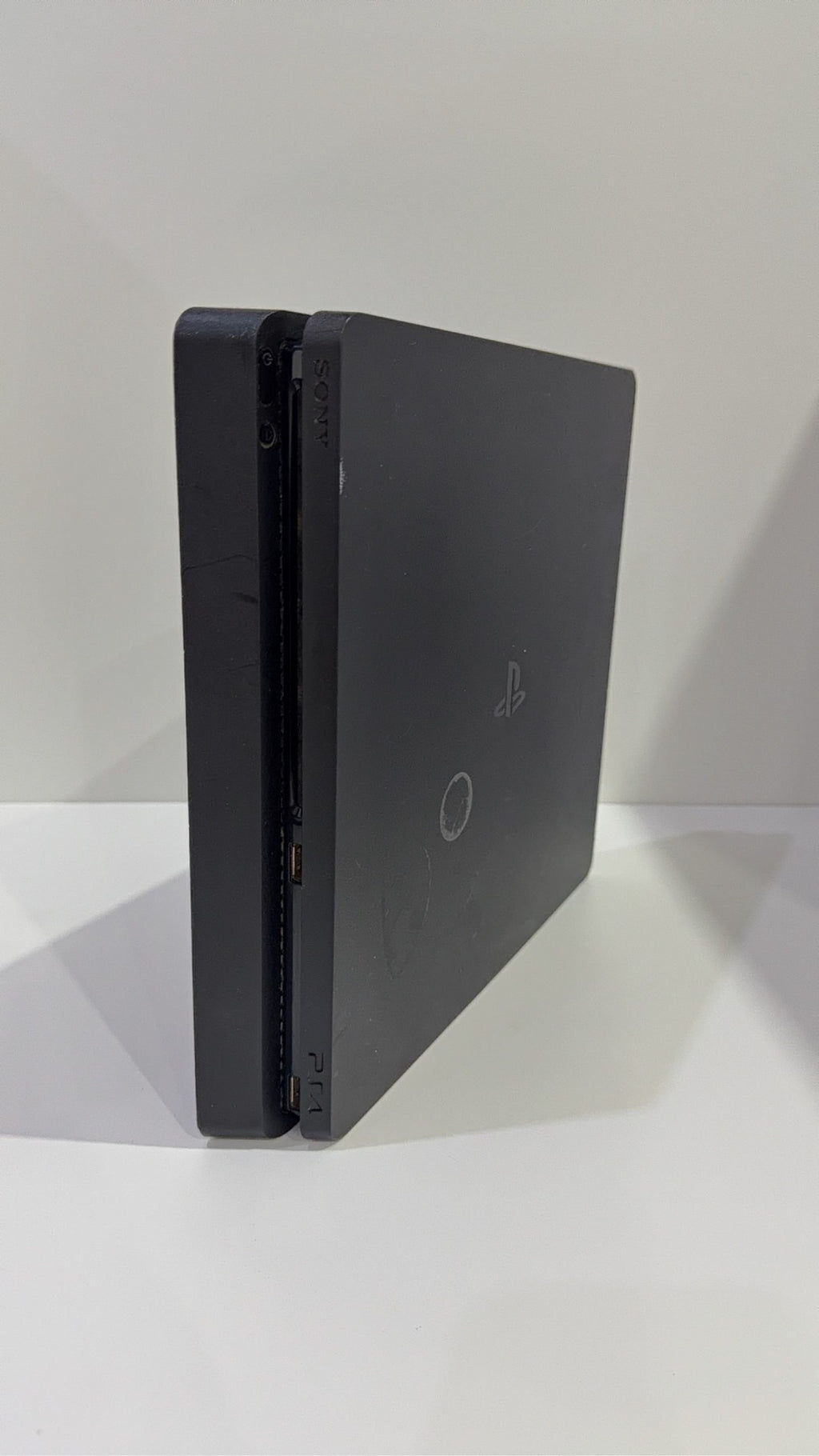 Sony PlayStation 4 Slim 500GB Black Console with Camo Controller and power cables.